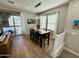 Dining area featuring a modern light fixture, neutral walls, and a sliding glass door at 155 N Lakeview Blvd # 207, Chandler, AZ 85225