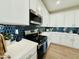 The kitchen features sleek white cabinets and subway tile backsplash, paired with modern appliances at 155 N Lakeview Blvd # 207, Chandler, AZ 85225