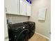 Laundry room featuring a side-by-side washer and dryer with upper cabinets at 155 N Lakeview Blvd # 207, Chandler, AZ 85225