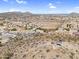 Expansive aerial view of property, showcasing desert landscape, mountain views and surrounding neighborhood at 1550 W Adobe Dam Dr, San Tan Valley, AZ 85144