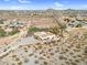 Desert home with a flat roof, surrounded by native vegetation, offers a private retreat with scenic views at 1550 W Adobe Dam Dr, San Tan Valley, AZ 85144