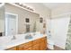 Bathroom featuring double sinks, large mirror, and a shower and tub combination at 1550 W Adobe Dam Dr, San Tan Valley, AZ 85144