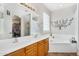 Bathroom featuring double sinks, large mirror, and a separate tub and shower at 1550 W Adobe Dam Dr, San Tan Valley, AZ 85144