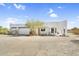 Charming white home featuring a desert landscape and a two-car garage with an inviting entrance area at 1550 W Adobe Dam Dr, San Tan Valley, AZ 85144