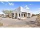 Home exterior featuring white stucco, covered porches, and desert landscaping at 1550 W Adobe Dam Dr, San Tan Valley, AZ 85144