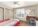 Bedroom featuring a window with white shutters, a ceiling fan, and an antique writing desk at 15620 N 19Th St, Phoenix, AZ 85022