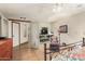 Bright bedroom featuring a ceiling fan, adjacent sitting area with a built-in shelving unit and a TV at 15620 N 19Th St, Phoenix, AZ 85022