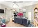 Bedroom featuring sliding closet doors, a ceiling fan, and a work table with sewing supplies at 15620 N 19Th St, Phoenix, AZ 85022