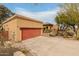 Exterior view showcasing the home's red garage door, private entrance, and desert landscaping at 15620 N 19Th St, Phoenix, AZ 85022