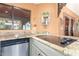 Close up of a well lit kitchen with granite countertops, a cooktop and stainless steel appliances at 15620 N 19Th St, Phoenix, AZ 85022