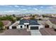 Stunning aerial view of a modern white home with a gray roof and desert landscaping at 15901 S Saxon Rd, Arizona City, AZ 85123