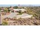 Overhead view of a desert home featuring a three-car garage and large concrete driveway and mature landscaping at 16611 E Inca Ave, Fountain Hills, AZ 85268