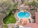 Aerial view of a home with a pool, patio, garden and pergola nestled in a lush desert landscape at 16611 E Inca Ave, Fountain Hills, AZ 85268