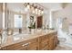 Elegant bathroom featuring a double vanity with granite countertops, decorative lighting, and a large mirror at 16611 E Inca Ave, Fountain Hills, AZ 85268