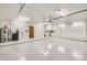 Large garage featuring white walls, a wooden side entry door, a water heater, and extensive cabinet space at 16611 E Inca Ave, Fountain Hills, AZ 85268