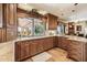 Well-lit kitchen with wooden cabinets and an open window to the backyard pool area at 16611 E Inca Ave, Fountain Hills, AZ 85268