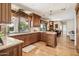 Open concept kitchen featuring wood cabinets, granite countertops, and backyard pool view at 16611 E Inca Ave, Fountain Hills, AZ 85268