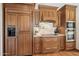 Kitchen with a stainless steel oven, wooden cabinets, and granite countertops at 16611 E Inca Ave, Fountain Hills, AZ 85268