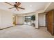 Bright living room boasting a ceiling fan, large sliding doors accessing the pool, and convenient access to an attached bathroom at 16611 E Inca Ave, Fountain Hills, AZ 85268