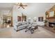 Inviting living room with high ceilings, a stone fireplace, and lots of natural light at 16611 E Inca Ave, Fountain Hills, AZ 85268