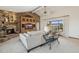 Open-concept living room with stone fireplace, built-ins, and views of a backyard pool at 16611 E Inca Ave, Fountain Hills, AZ 85268