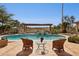 Inviting pool area with comfortable seating and a pergola, perfect for relaxing and enjoying the serene desert view at 16611 E Inca Ave, Fountain Hills, AZ 85268