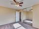 This bedroom features neutral walls, carpet flooring, a ceiling fan, and a mirrored sliding door closet at 17025 W Rimrock St, Surprise, AZ 85388