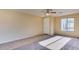 Spacious room with plush carpeting, neutral paint, a ceiling fan, and natural lighting from the window at 17025 W Rimrock St, Surprise, AZ 85388