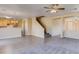 Open-concept room featuring tile flooring, carpeting, a staircase, and lots of space for entertaining at 17025 W Rimrock St, Surprise, AZ 85388