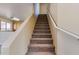 Carpeted staircase leading to the upper level of the home with white handrails at 17025 W Rimrock St, Surprise, AZ 85388