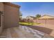 View of tiled backyard patio, gravel area, and block wall fencing at 1756 E Cardinal Dr, Casa Grande, AZ 85122