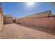 Gravel-covered backyard with block wall fencing, and desert landscaping at 1756 E Cardinal Dr, Casa Grande, AZ 85122