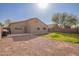 Backyard features gravel area, block wall fencing, and lush desert landscaping at 1756 E Cardinal Dr, Casa Grande, AZ 85122