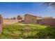 Spacious backyard with grass, block wall fencing, and desert landscaping at 1756 E Cardinal Dr, Casa Grande, AZ 85122