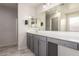 Bathroom featuring double vanity, grey cabinets and a large mirror at 1756 E Cardinal Dr, Casa Grande, AZ 85122