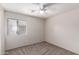 A clean, carpeted bedroom with a ceiling fan and a window providing natural light at 1756 E Cardinal Dr, Casa Grande, AZ 85122