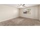 Cozy bedroom with neutral carpet, ceiling fan and a window with blinds at 1756 E Cardinal Dr, Casa Grande, AZ 85122