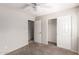 This bedroom features plush carpet, a ceiling fan, with a closet and ensuite bathroom at 1756 E Cardinal Dr, Casa Grande, AZ 85122