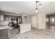 Modern kitchen with stainless appliances, gray cabinets and island opens to living area at 1756 E Cardinal Dr, Casa Grande, AZ 85122