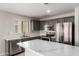 Updated kitchen featuring stainless steel appliances, gray cabinets, and marble countertops at 1756 E Cardinal Dr, Casa Grande, AZ 85122