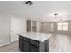 Kitchen island with marble countertops opens to living area with stylish pendant lighting at 1756 E Cardinal Dr, Casa Grande, AZ 85122