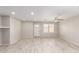 Bright living room with wood-look flooring, ceiling fan, neutral paint and a door to the outside at 1756 E Cardinal Dr, Casa Grande, AZ 85122