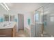 Well-lit bathroom featuring double sinks, a soaking tub, and a separate glass-enclosed shower at 1805 E Aloe Pl, Chandler, AZ 85286