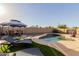 Backyard features a sparkling pool, gazebo, sun loungers, and basketball hoop at 18842 N Lariat Rd, Maricopa, AZ 85138