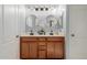 Bathroom featuring double sinks, wood cabinets, and white countertop at 18842 N Lariat Rd, Maricopa, AZ 85138