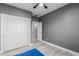 Bedroom with ceiling fan, closet with sliding doors, and an open doorway at 18842 N Lariat Rd, Maricopa, AZ 85138