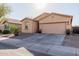 Street view of a single-story home with desert landscaping and a two-car garage at 18842 N Lariat Rd, Maricopa, AZ 85138