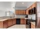 Well lit kitchen featuring tile floors, wooden cabinets, and modern appliances at 18842 N Lariat Rd, Maricopa, AZ 85138