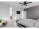 Main bedroom featuring an upholstered bed and a doorway to the ensuite bath at 18842 N Lariat Rd, Maricopa, AZ 85138