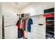 Well-organized closet featuring built-in storage and a stackable washer/dryer at 2228 W Harmont Dr, Phoenix, AZ 85021